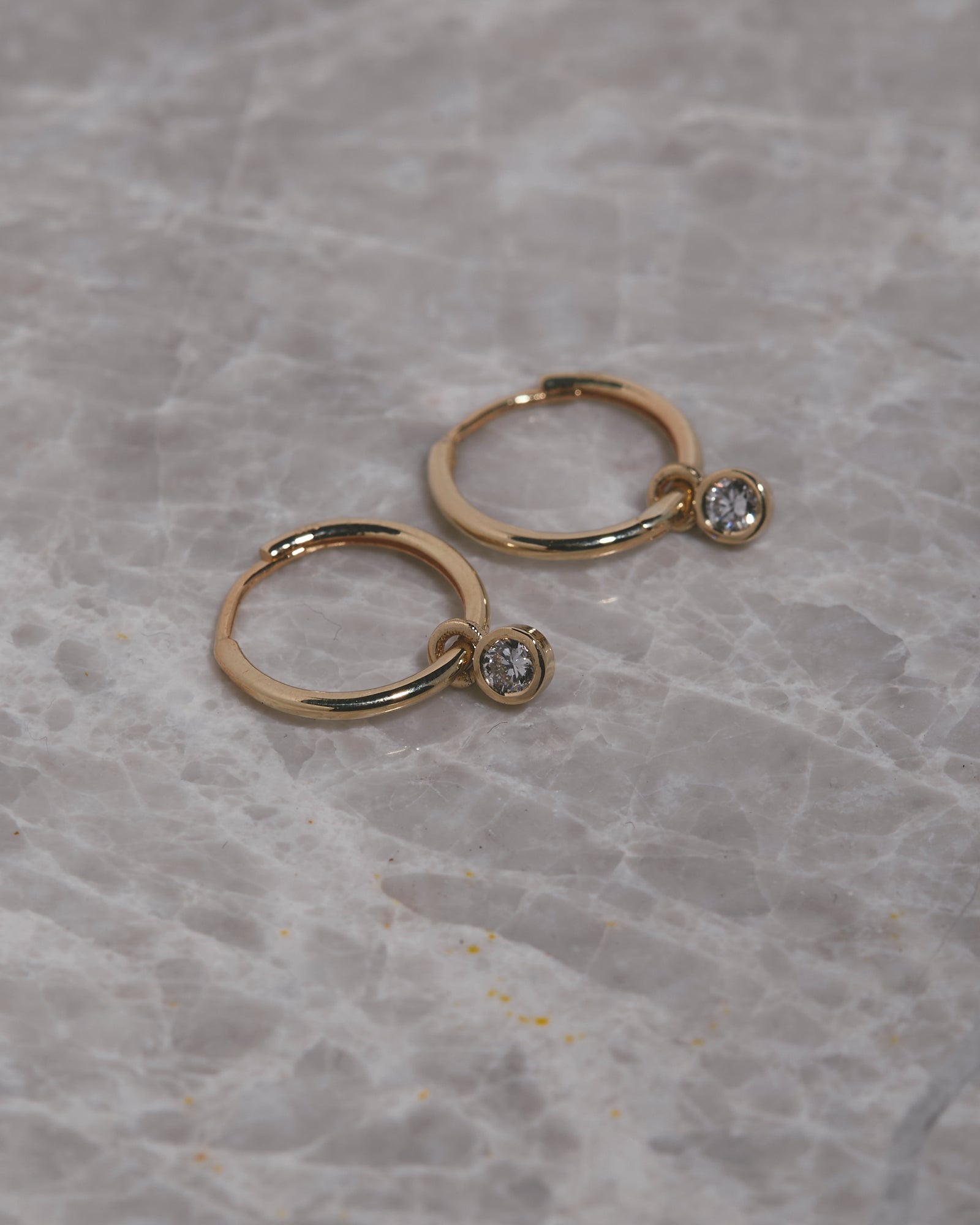 Small hinged hoops with diamond charms