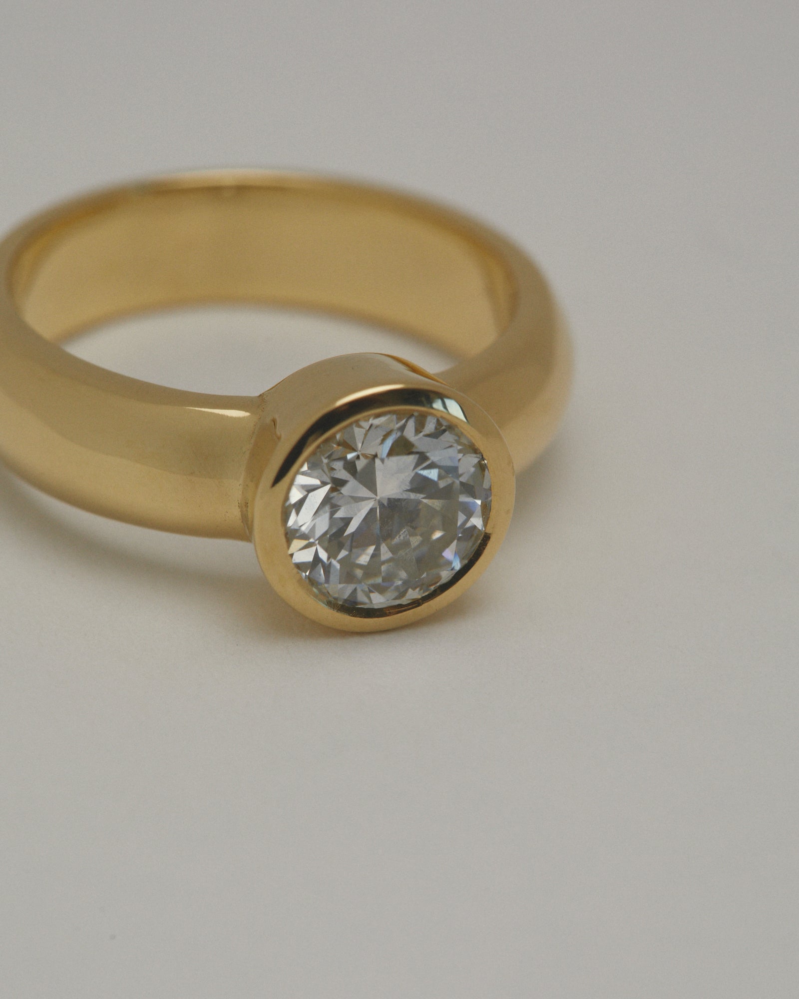 1.402ct early round brilliant cut diamond chunky bezel solitaire.