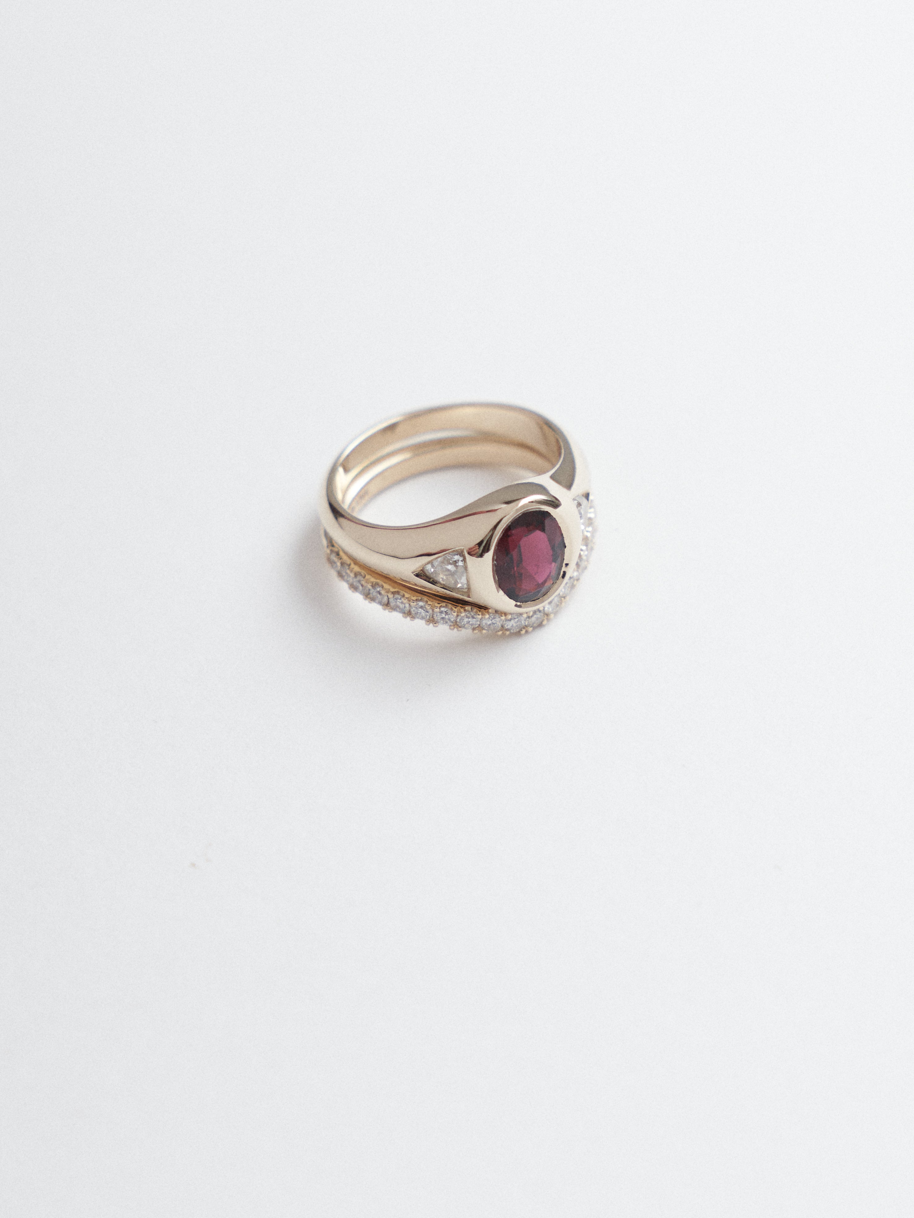 1.10ct oval cut rubelite tourmaline signet trilogy and wedding band.