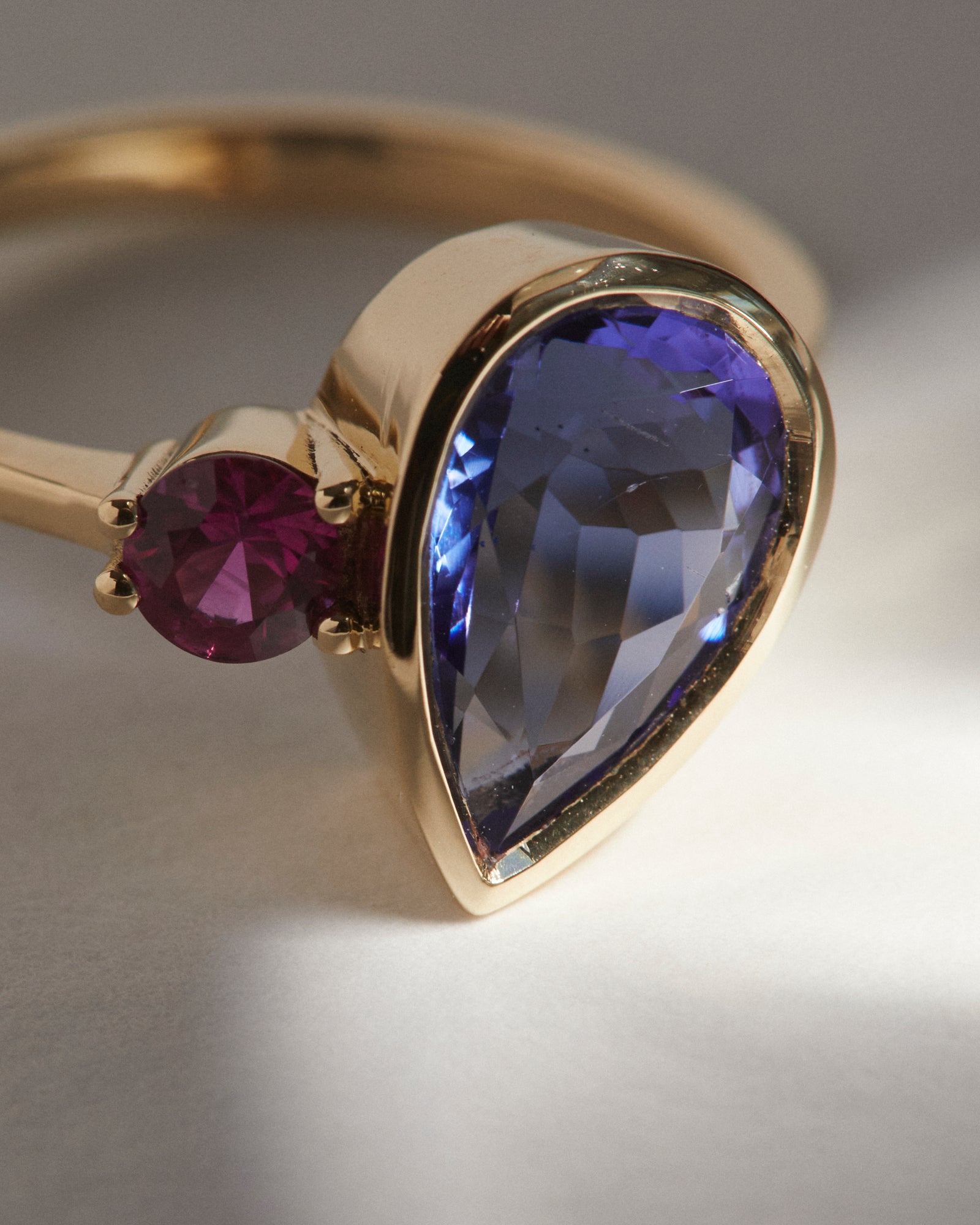 2.638ct Pear shape tanzanite and 0.272ct round cut ruby Toi et Moi ring.