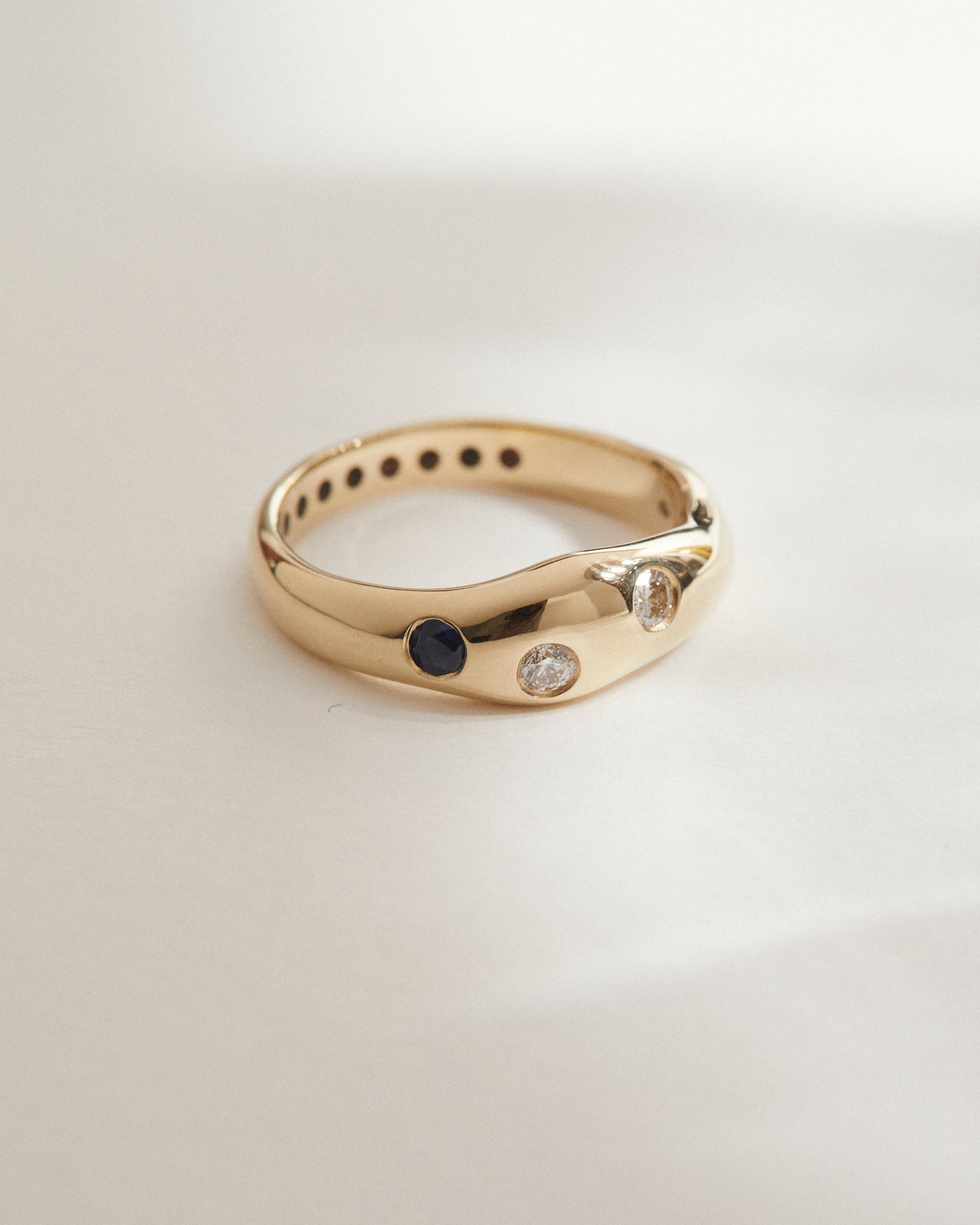 Organic wedding band with sapphire and diamonds.