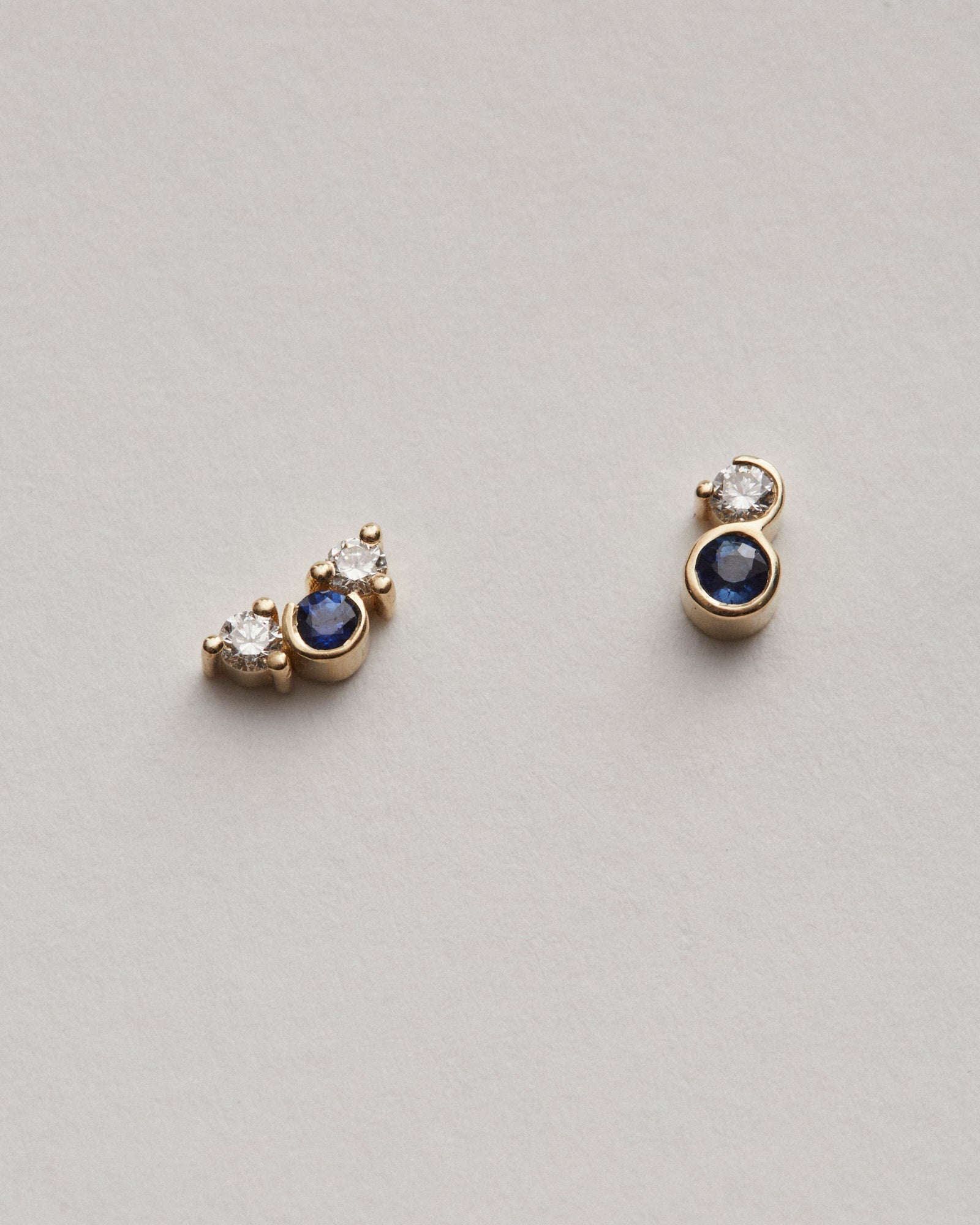 Mis-matched diamond and sapphire studs.