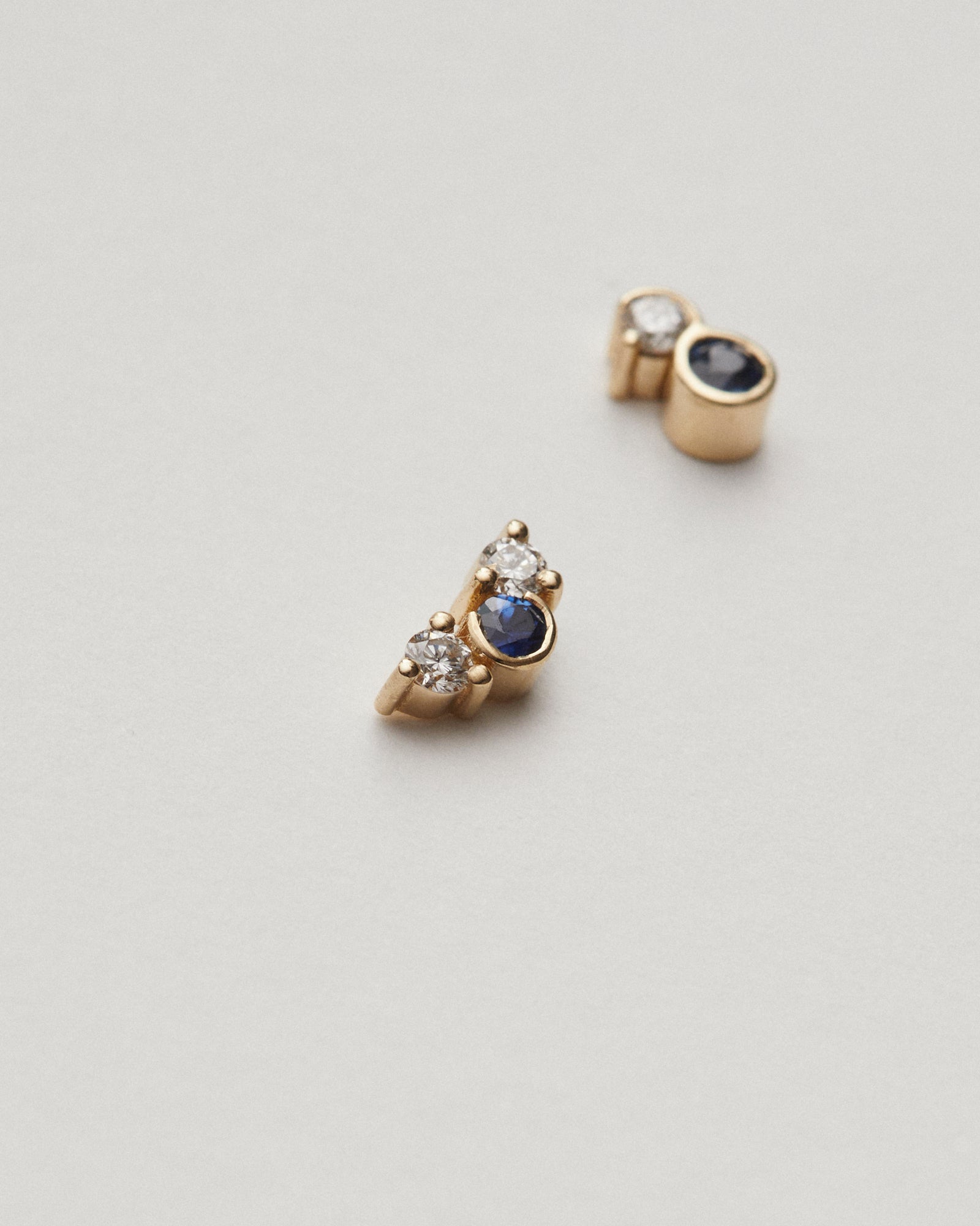 Mis-matched diamond and sapphire studs.